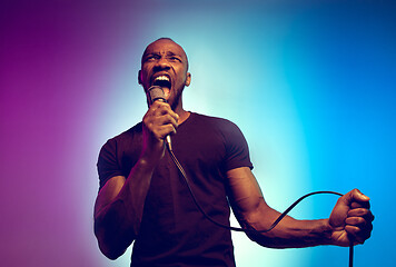 Image showing Young african-american jazz musician singing a song