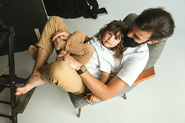 Image showing Father playing with young son in their sitting room