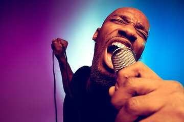 Image showing Young african-american jazz musician singing a song