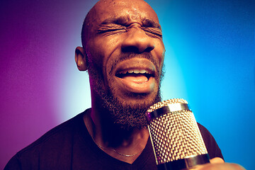 Image showing Young african-american jazz musician singing a song