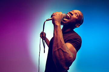 Image showing Young african-american jazz musician singing a song