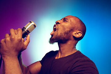 Image showing Young african-american jazz musician singing a song