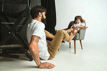 Image showing Father playing with young son in their sitting room