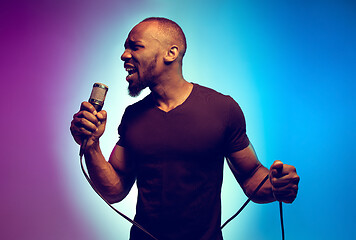 Image showing Young african-american jazz musician singing a song