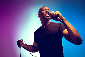 Image showing Young african-american jazz musician singing a song