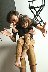 Image showing Father playing with young son in their sitting room