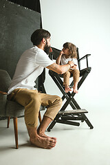 Image showing Father playing with young son in their sitting room