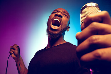 Image showing Young african-american jazz musician singing a song