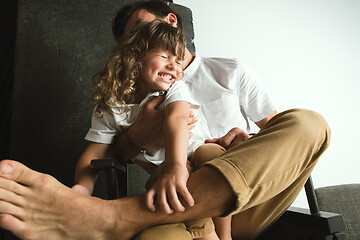 Image showing Father playing with young son in their sitting room