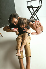 Image showing Father playing with young son in their sitting room