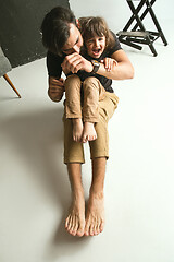 Image showing Father playing with young son in their sitting room