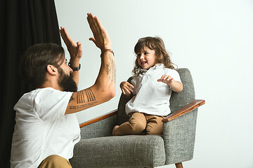 Image showing Father playing with young son in their sitting room