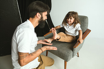 Image showing Father playing with young son in their sitting room