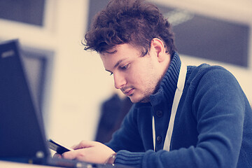 Image showing Young casual businessman using smartphone