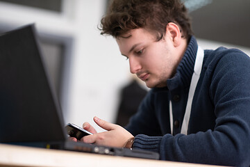 Image showing Young casual businessman using smartphone