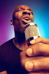 Image showing Young african-american jazz musician singing a song