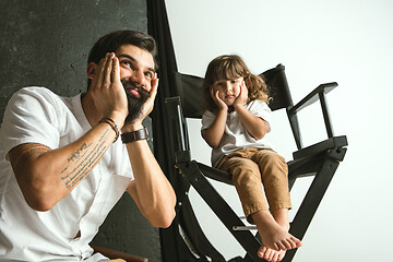 Image showing Father playing with young son in their sitting room