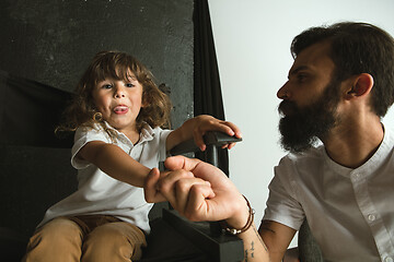 Image showing Father playing with young son in their sitting room