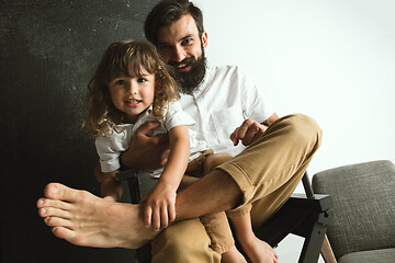 Image showing Father playing with young son in their sitting room