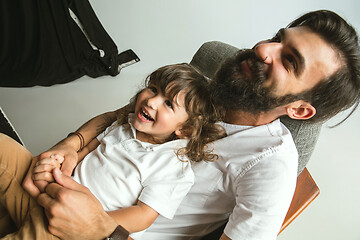 Image showing Father playing with young son in their sitting room