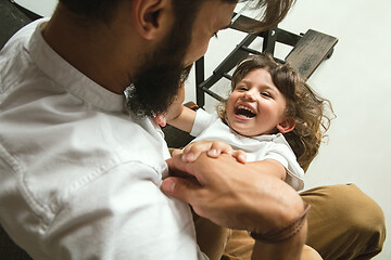 Image showing Father playing with young son in their sitting room