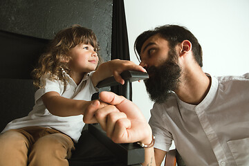 Image showing Father playing with young son in their sitting room