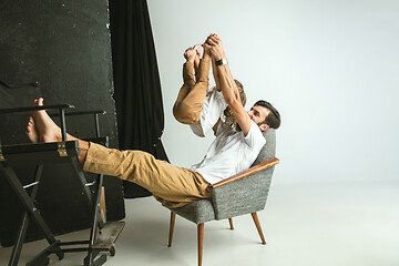 Image showing Father playing with young son in their sitting room