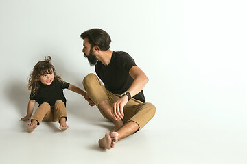 Image showing Father playing with young son against white studio background