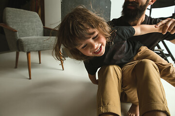 Image showing Father playing with young son in their sitting room