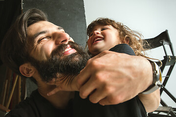 Image showing Father playing with young son in their sitting room