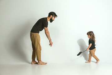 Image showing Father playing with young son against white studio background