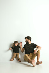 Image showing Father playing with young son against white studio background