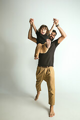 Image showing Father playing with young son against white studio background