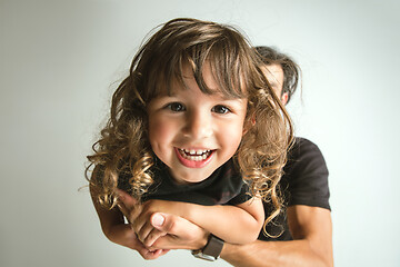 Image showing Father playing with young son against white studio background