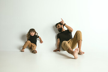 Image showing Father playing with young son against white studio background