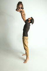 Image showing Father playing with young son against white studio background