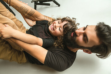 Image showing Father playing with young son in their sitting room