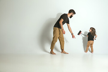 Image showing Father playing with young son against white studio background