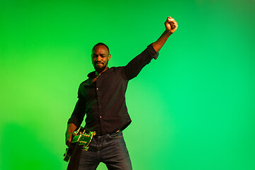 Image showing Young african-american jazz musician playing the guitar