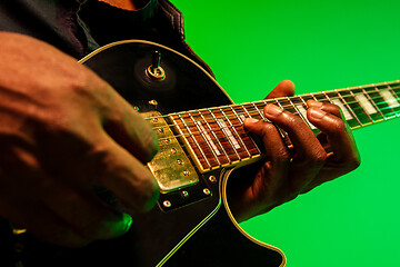 Image showing Young african-american jazz musician playing the guitar