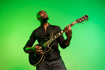 Image showing Young african-american jazz musician playing the guitar