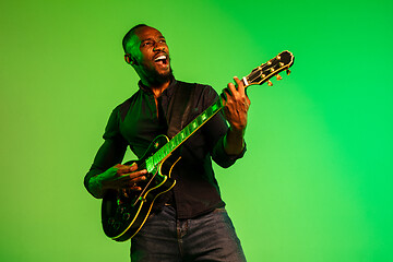 Image showing Young african-american jazz musician playing the guitar