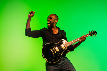 Image showing Young african-american jazz musician playing the guitar