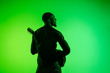 Image showing Young african-american jazz musician playing the guitar