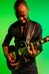 Image showing Young african-american jazz musician playing the guitar