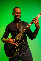 Image showing Young african-american jazz musician playing the guitar