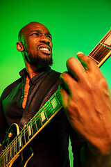 Image showing Young african-american jazz musician playing the guitar