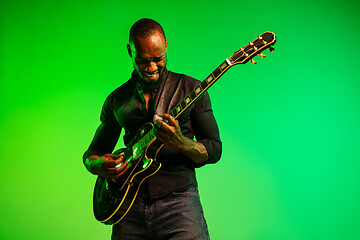 Image showing Young african-american jazz musician playing the guitar