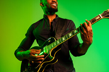 Image showing Young african-american jazz musician playing the guitar