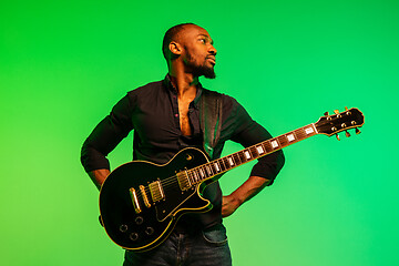 Image showing Young african-american jazz musician playing the guitar